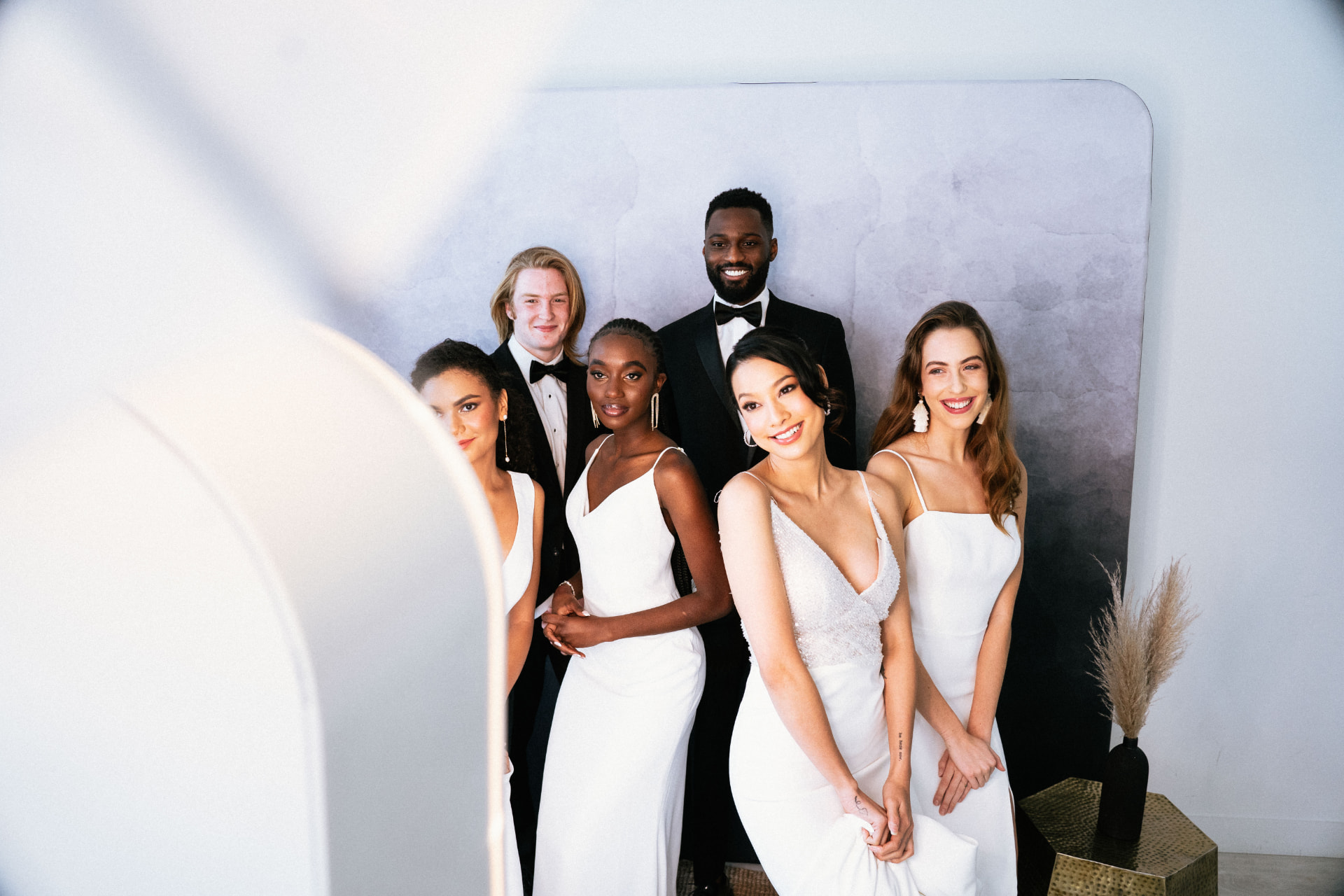 Wedding party in formal attire stepping into the ring-lit Palm Tree Photo Booth