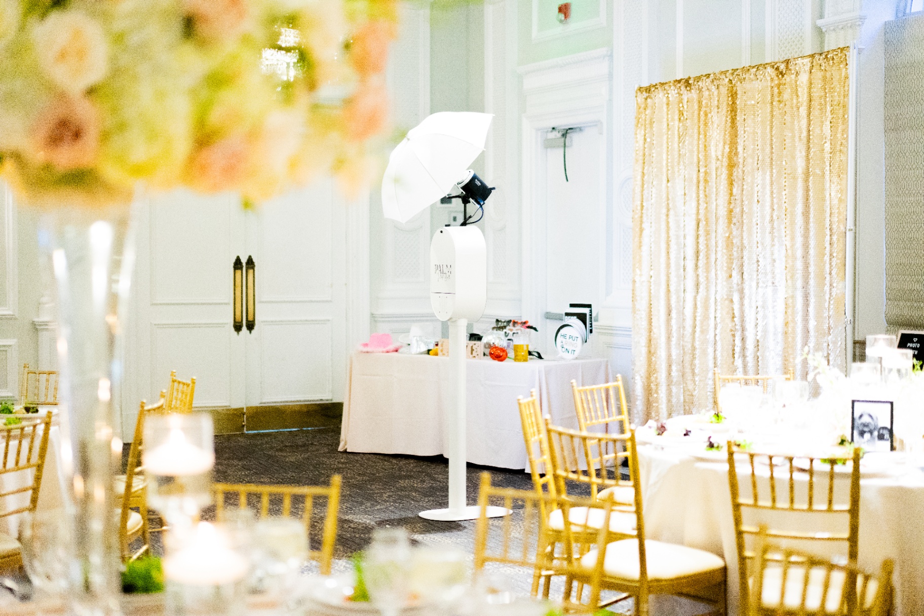 The Palm Tree Photo Booth elegantly styled inside a bright luxury wedding reception venue