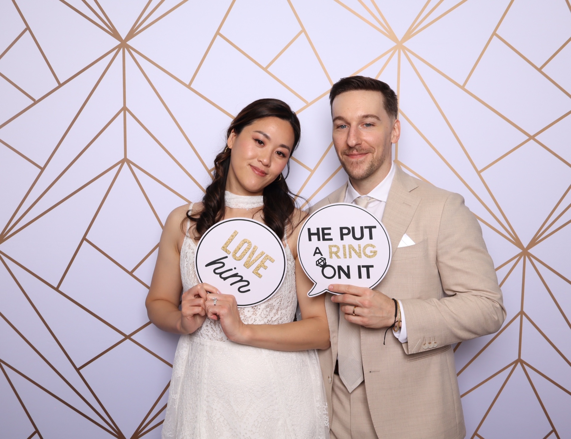 Bride and groom holding playful signs during their Luxe Studio color portrait session